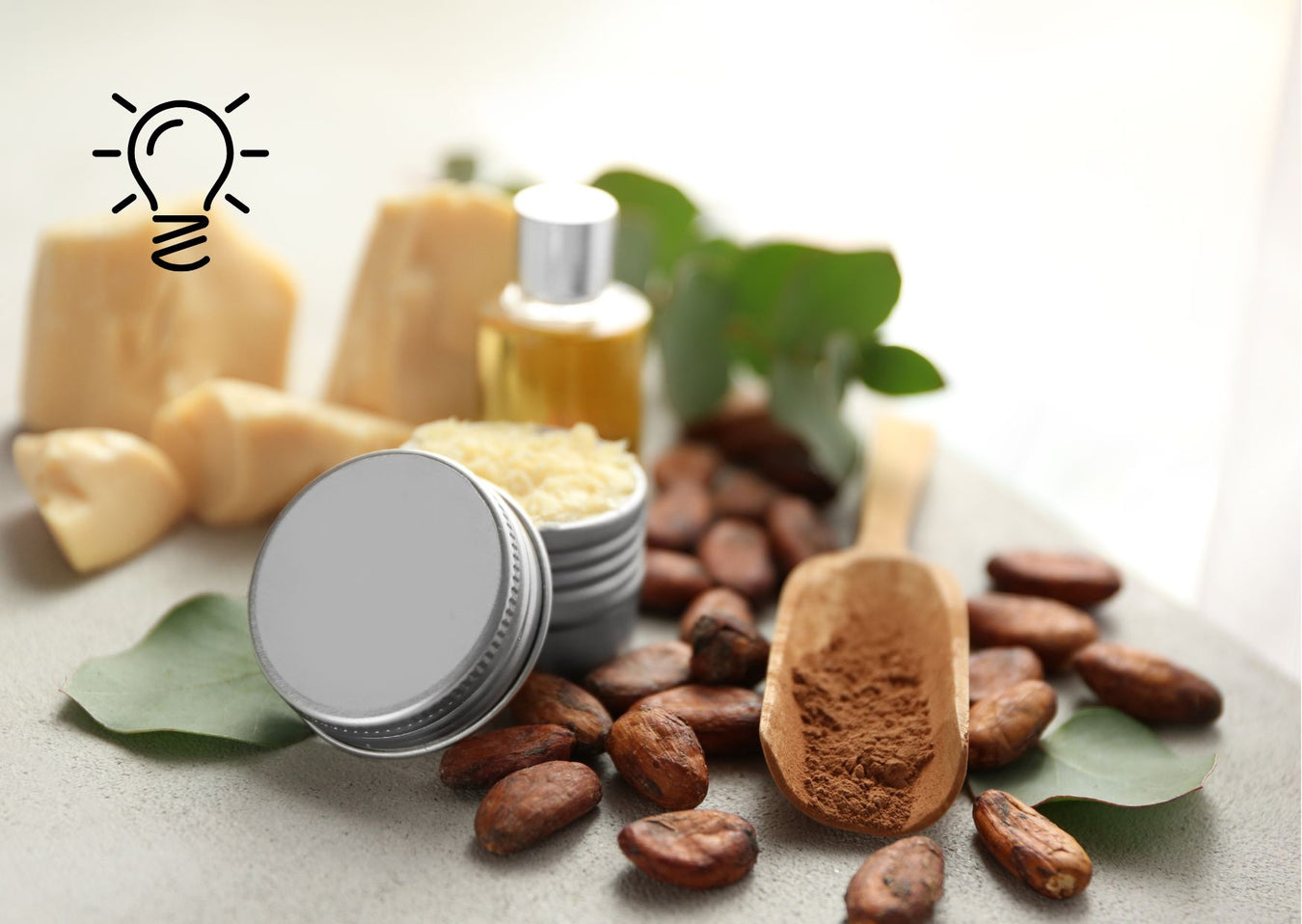 Just Gentle baby lotion tins with cocoa butter, cacao beans, oil, and eucalyptus leaves in a natural setting