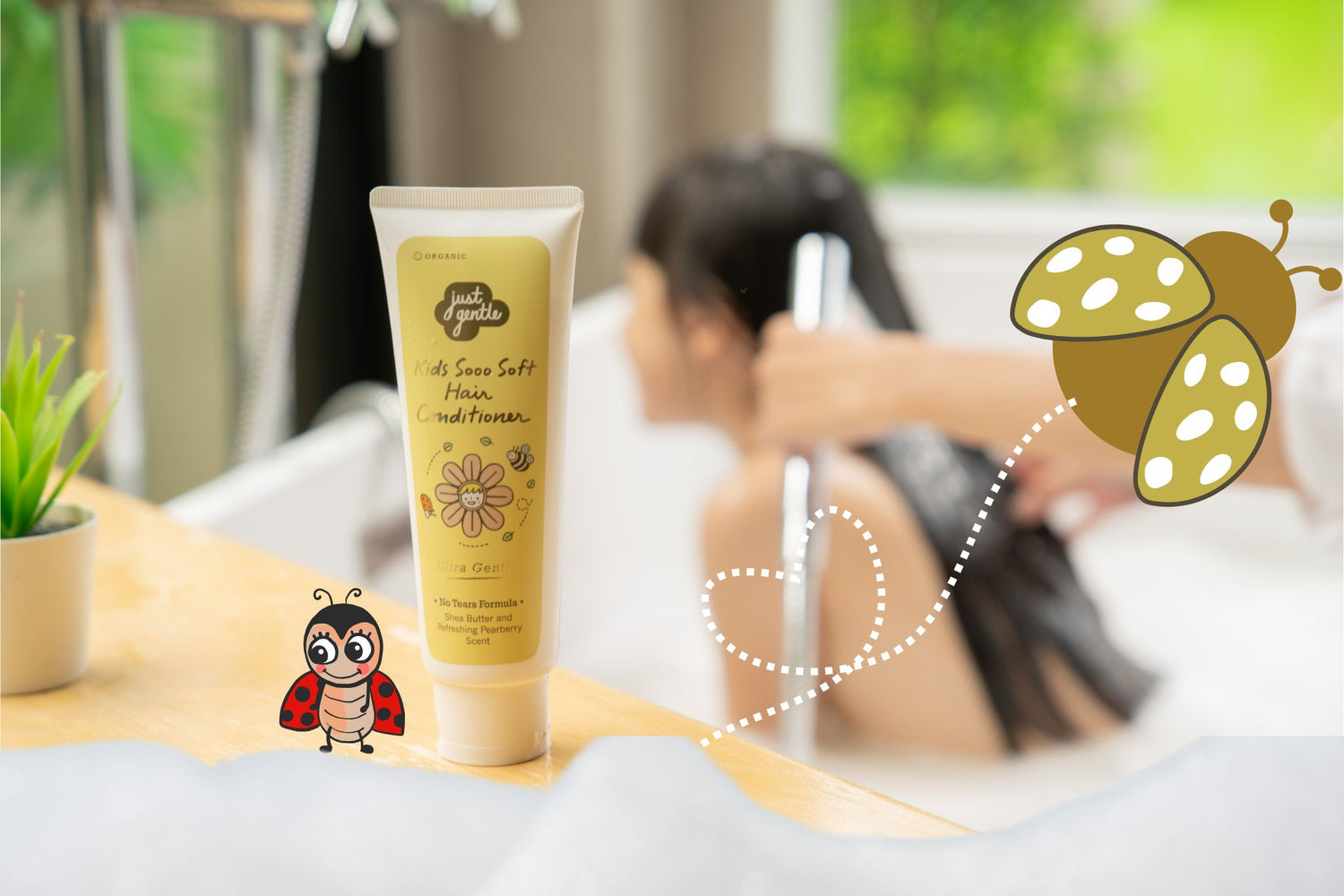 Just Gentle Kids Sooo Soft Hair Conditioner tube on bathroom counter while child rinses hair, with playful ladybug graphics.