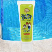 "Swim & Sport shampoo bottle floating above a pool with clear water and ripple reflections."