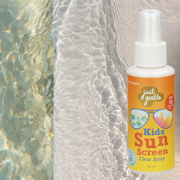 Just Gentle Baby and Kids Sun Protection Roll-On on a stone ledge beside the water
