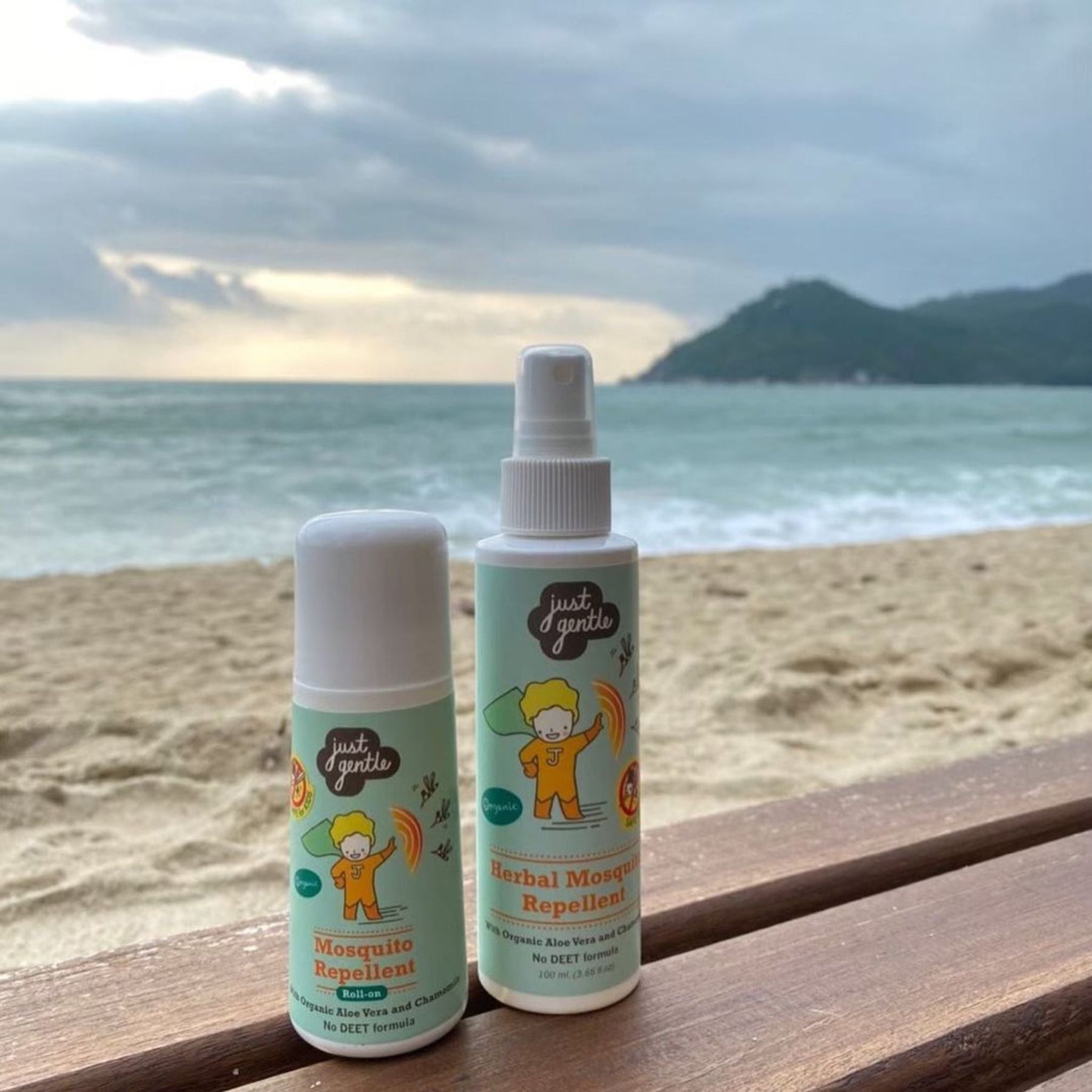 Just Gentle Herbal Mosquito Repellent roll-on and spray on a beach bench