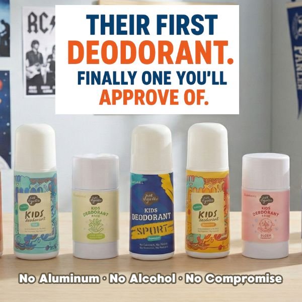 Collection of Just Gentle children's deodorants on a wooden surface with promotional text about ingredients.