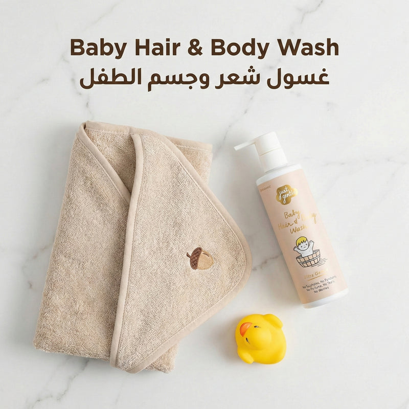 'Just Gentle' Baby hair and body wash with a towel and rubber duck on a marble surface