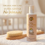 Just Gentle Baby hair and body wash bottle with a brush on a soft surface, featuring 'Just Gentle' branding.