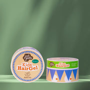 Two containers of 'Just & Gentle' Kids Hair Gel on a green background