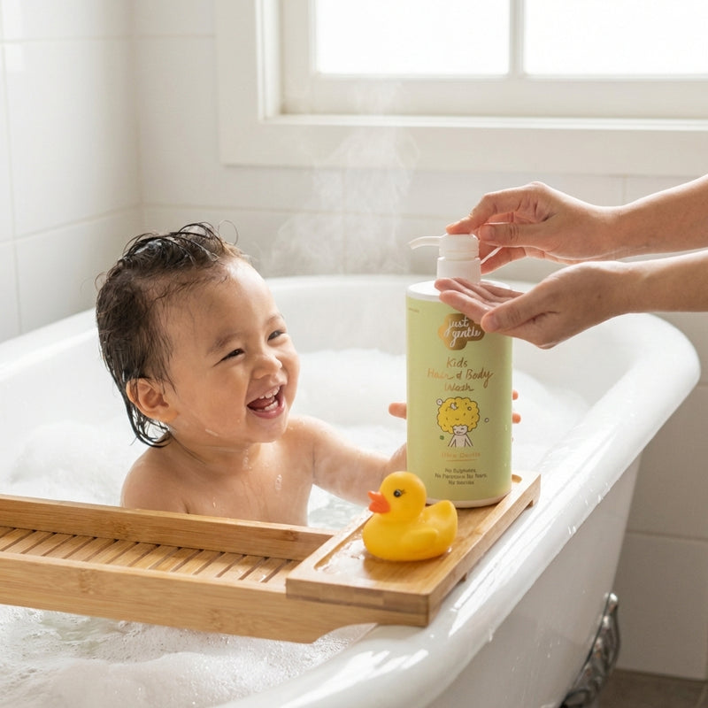 Child in a bathtub with a bottle of Just gentle Kids' shampoo and a rubber duck