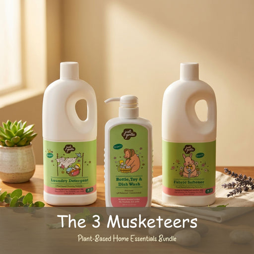 Three bottles of 'The 3 Musketeers' plant-based home essentials on a wooden surface with a soft focus background.