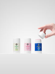 Hand opening Just Gentle kids sport deodorant next to unscented and bloom natural deodorant sticks